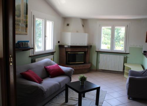 a living room with a couch and a fireplace at Relax and apartment in SantʼAgata Feltria