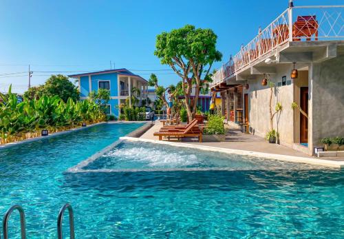 a swimming pool in front of a house at Janpa Resort in Don Sak