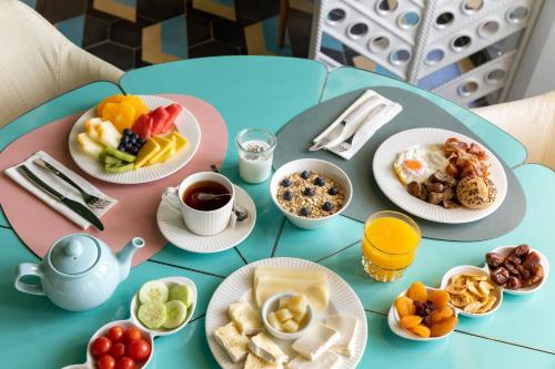 a blue table topped with plates of breakfast foods at Room Mate Macarena, Madrid Gran Vía in Madrid