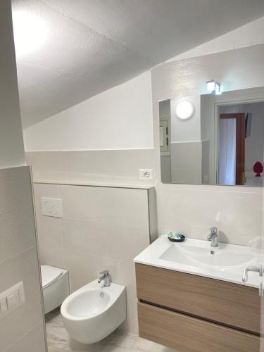 a bathroom with a sink and a toilet and a mirror at Vista al Tramonto B&B in Falerna