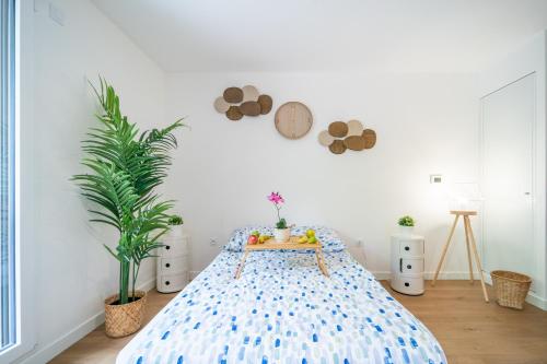 a bedroom with a large bed with a blue bedspread at Sensations - Studio dans le quartier daffaires in Rueil-Malmaison