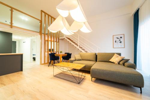 a living room with a couch and a table at Apartamenty Prusa in Mikołajki