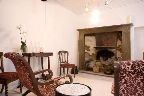 a room with a table and chairs and a fireplace at Dimora Vittoria - Lago Maggiore in Casalzuigno