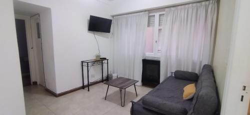 a living room with a couch and a chair at Departamento Las Heras in Mar del Plata