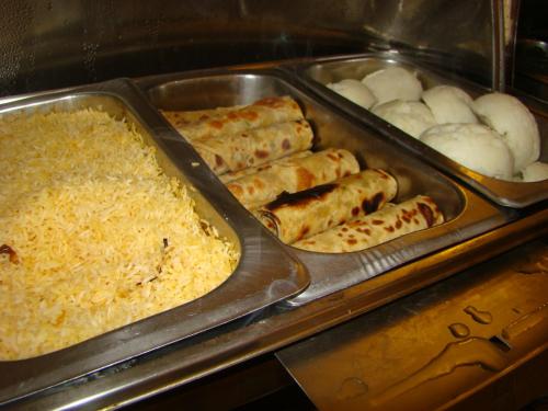 a tray of food with rice and other foods at ACK Guest House Nairobi in Nairobi