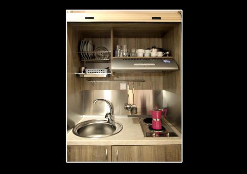 a kitchen with a sink and a counter top at Sea View Apollo Apartments & Studios in Afytos in Afitos