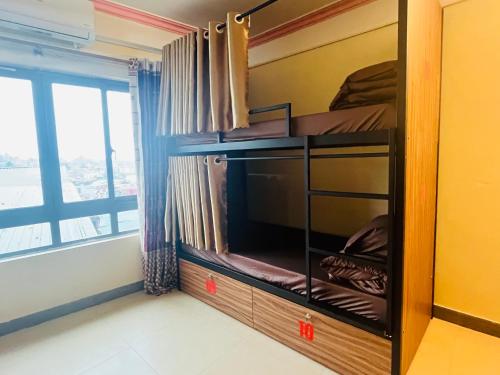 a room with a bedroom with a tv and a window at Sapa Paramount Hotel in Sa Pa