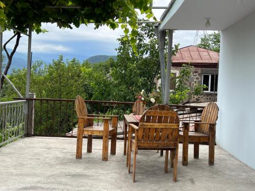 a wooden table and chairs on a patio with a view at Arman Bed and Breakfast in Halidzor