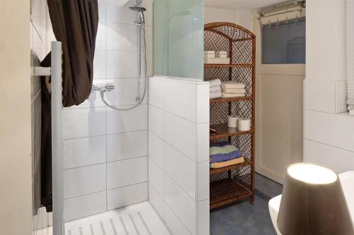 a bathroom with a shower with white tiles at Ferienwohnung Gill in Staufen