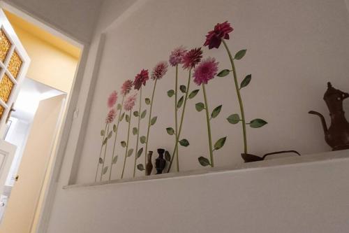 a wall with a bunch of flowers painted on it at Lefterakis place in Aegina Town