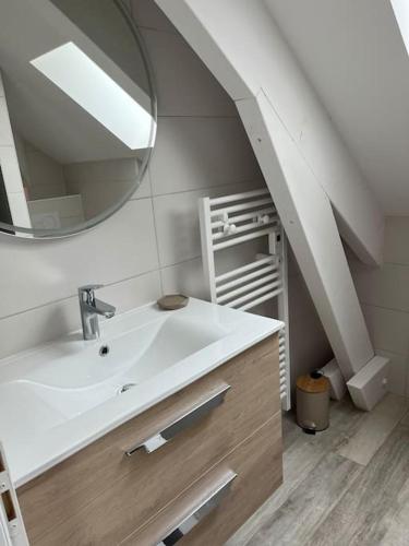 a bathroom with a sink and a mirror at La Girase in Saint-Gilles-Croix-de-Vie