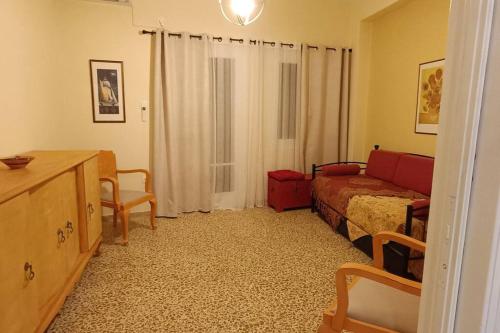 a room with a bedroom with a bed and a desk at Lefterakis place in Aegina Town