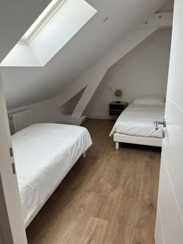 two beds in a room with a attic at La Girase in Saint-Gilles-Croix-de-Vie
