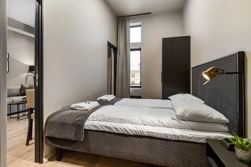 a bedroom with a large bed in a room at The APARTMENTS Company- Frogner in Oslo