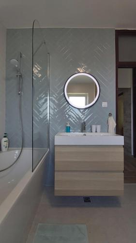 a bathroom with a sink and a mirror at Apartman Nada in Ozalj