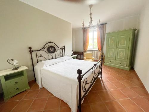a bedroom with a large bed and a window at Cascina Solaro in Asti