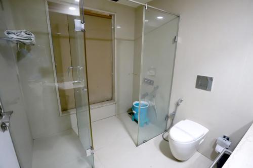 a bathroom with a shower and a toilet at HOTEL BLUE PEARL in Bhopal