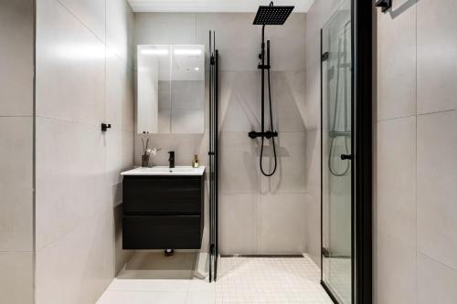a bathroom with a sink and a shower at The APARTMENTS Company- Frogner in Oslo