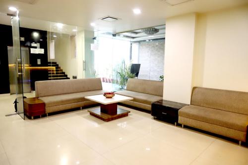 a lobby with couches and a table in a room at HOTEL BLUE PEARL in Bhopal