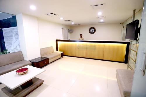 a man is standing in a living room at HOTEL BLUE PEARL in Bhopal