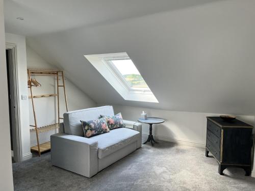 a living room with a chair and a skylight at River View in Keynsham