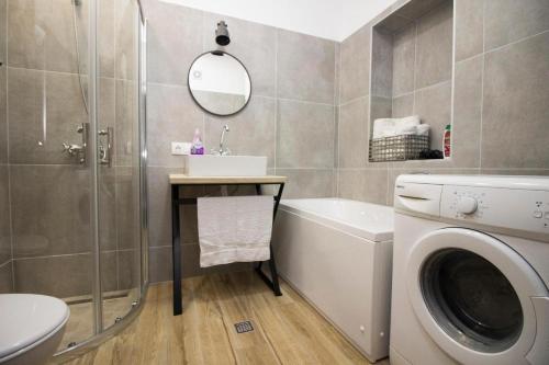 a bathroom with a washing machine and a sink at Villa Village Mostar in Mostar