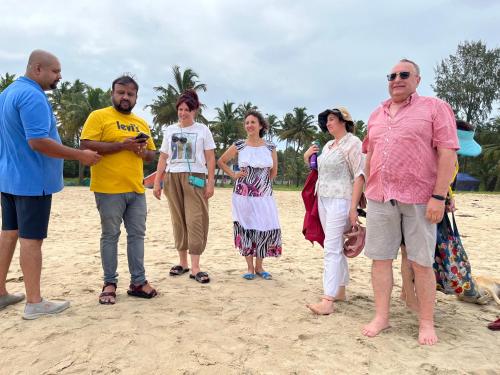 a group of people standing on the beach at Marari Beach Villas in Mararikulam