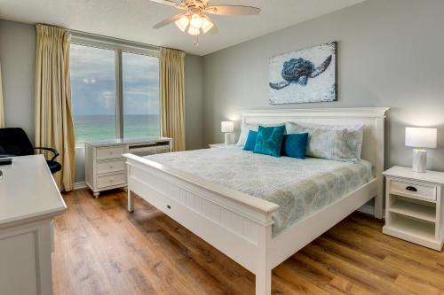 um quarto com uma cama branca e vista para o oceano em Fort Walton Beach Rental with Pool and Hot Tub Access em Fort Walton Beach