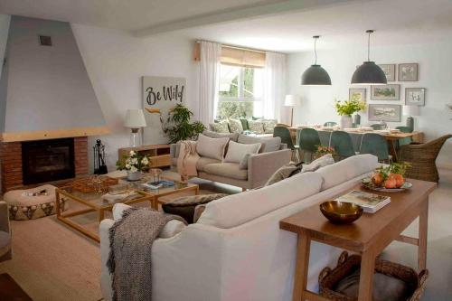 a living room with white furniture and a fireplace at Wishome - Villa Bonita en Alicante in Elche