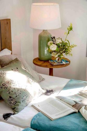 an open book laying on a bed with a lamp at Wishome - Villa Bonita en Alicante in Elche