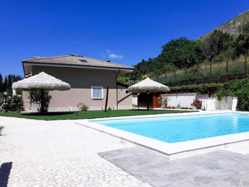 a villa with a swimming pool in front of a house at TorrediLuna - MoonTower 