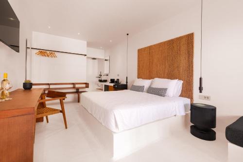 a white bedroom with a white bed and a desk at Akre Hotel - Designed for Adults in Naxos Chora