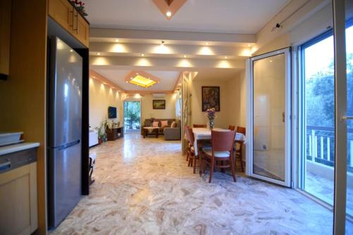 a living room with a table and a dining room at Villa Eirini Agia Varvara Lesvos in Plomarion