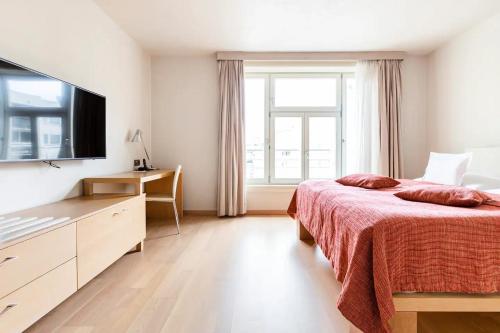 a bedroom with a bed and a large window at Roset Hotel & Residence in Bratislava