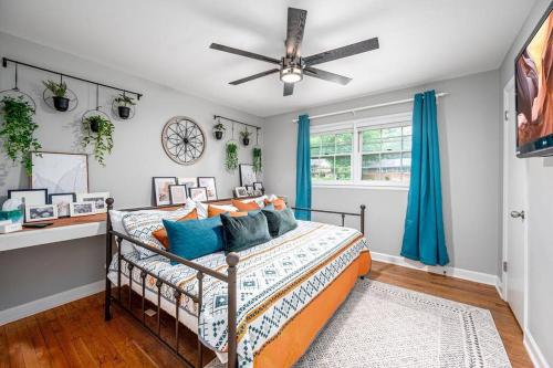 a bedroom with a bed and a ceiling fan at Pet Friendly Cozy 3BRM fully Fenced yard in Durham