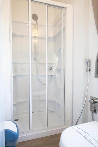 a shower with a glass door in a bathroom at hu Roma Camping In Town in Rome
