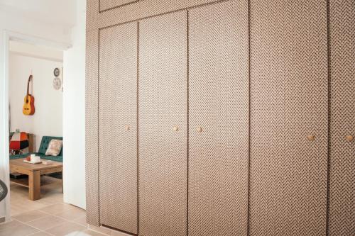 a room with a bunch of cabinets in a room at Villager's Art Apartment in Paradeísion