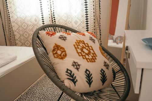 a pillow on a chair in a room at Villager's Art Apartment in Paradeísion