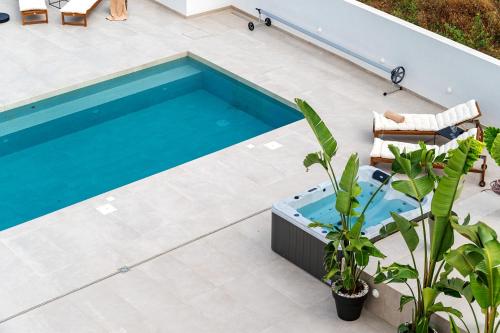 a swimming pool on a patio next to a house at Luxury Villa Del Sogno with pool, jacuzzi, parking in Trogir