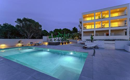 a swimming pool in front of a building at Luxury Villa Del Sogno with pool, jacuzzi, parking in Trogir