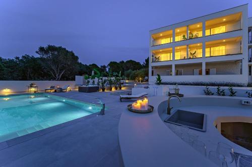 a house with a swimming pool and a building at Luxury Villa Del Sogno with pool, jacuzzi, parking in Trogir