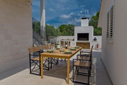 a dining room with a table and chairs on a patio at Luxury Villa Del Sogno with pool, jacuzzi, parking in Trogir