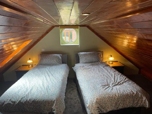 two beds in a small room in a attic at The Annexe at Gomo in East Winch