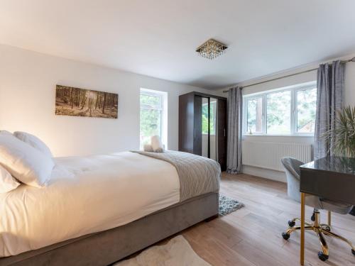 a bedroom with a large bed and a desk at Pass the Keys Gorgeous Central House in Bournemouth