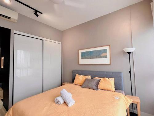 a bedroom with a bed with two towels on it at Studio Staycation D'Sara @ Linked MRT, Near Thomson Hospital & Sungai Buloh Hospital in Sungai Buluh