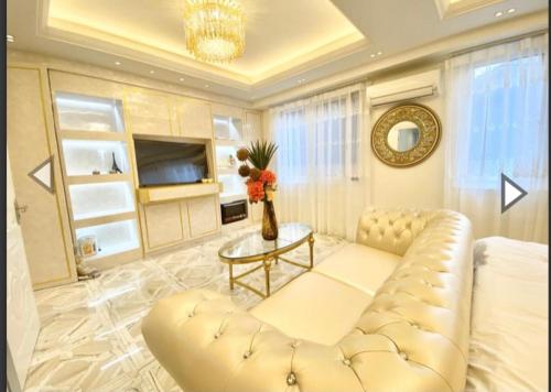 a living room with a white couch and a table at Reimi Mondo9 in Tokyo