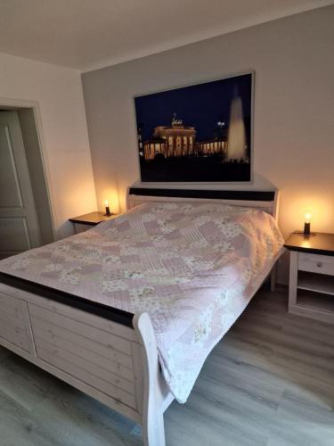 a bedroom with a large bed with two tables at Rema Ferienwohnungen in Zossen