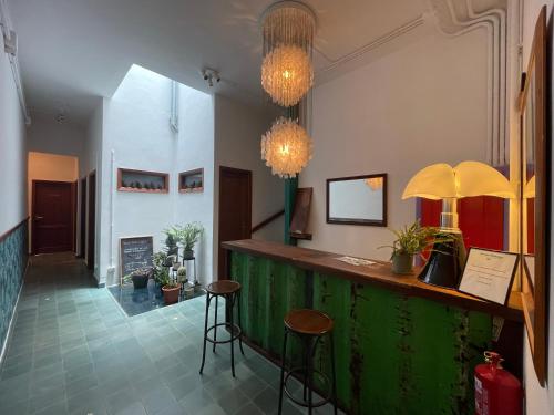 un bar con due sgabelli e un bancone verde di Hostal Bubango a San Andres y Sauces