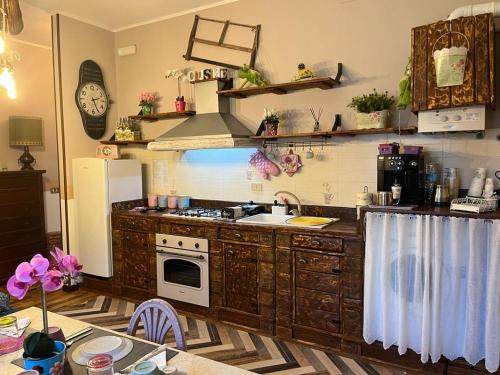 a kitchen with a stove and a refrigerator at Casa vacanze villa Lido- Pangrazi Alessandra in LʼAquila