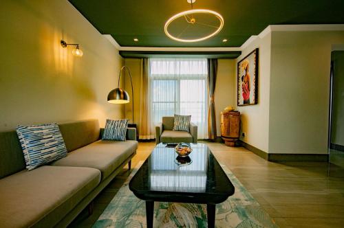 a living room with a couch and a coffee table at BELAN HOTEL de NGOZI in Ngozi